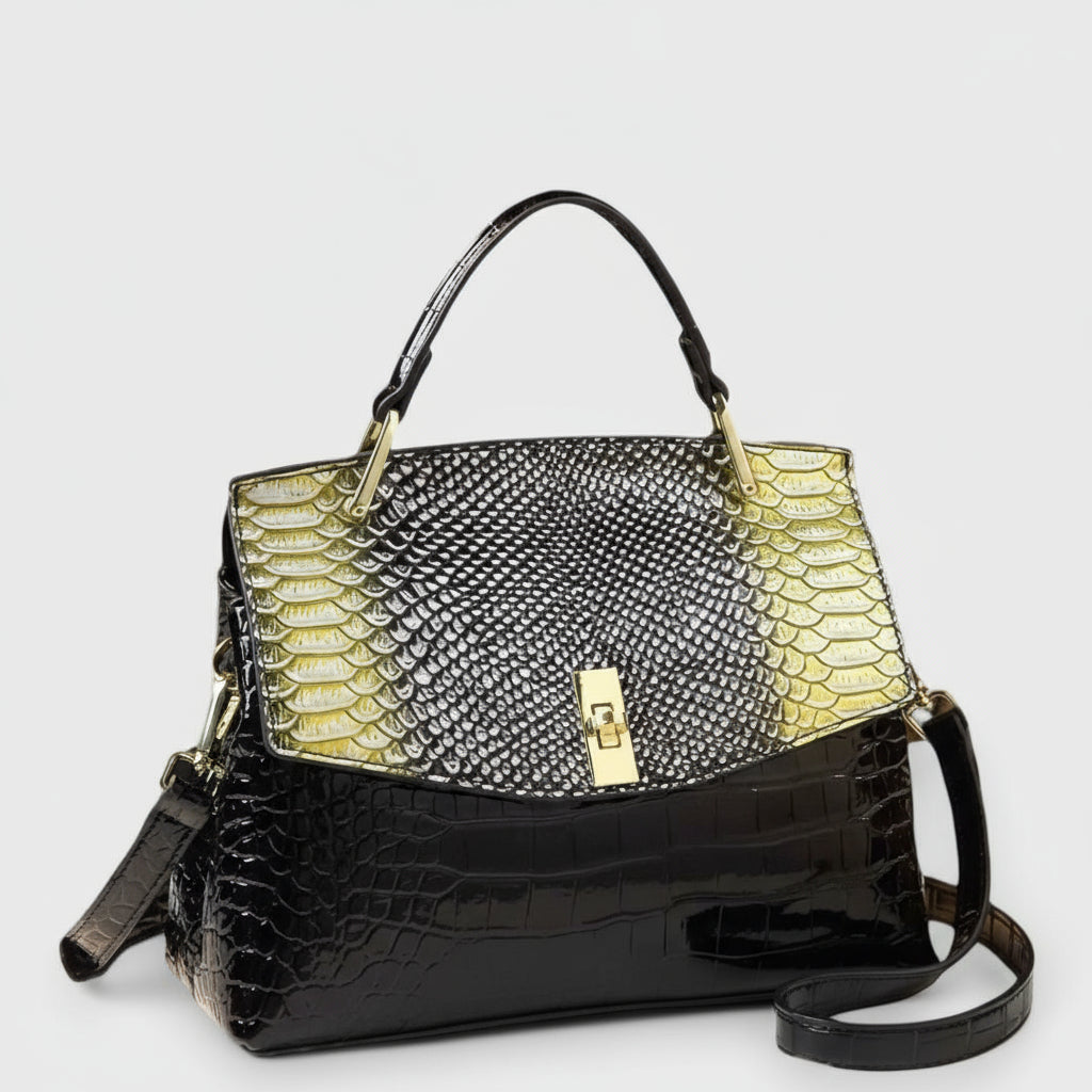 Handbag with black crocodile texture and yellow snake skin pattern on a white background