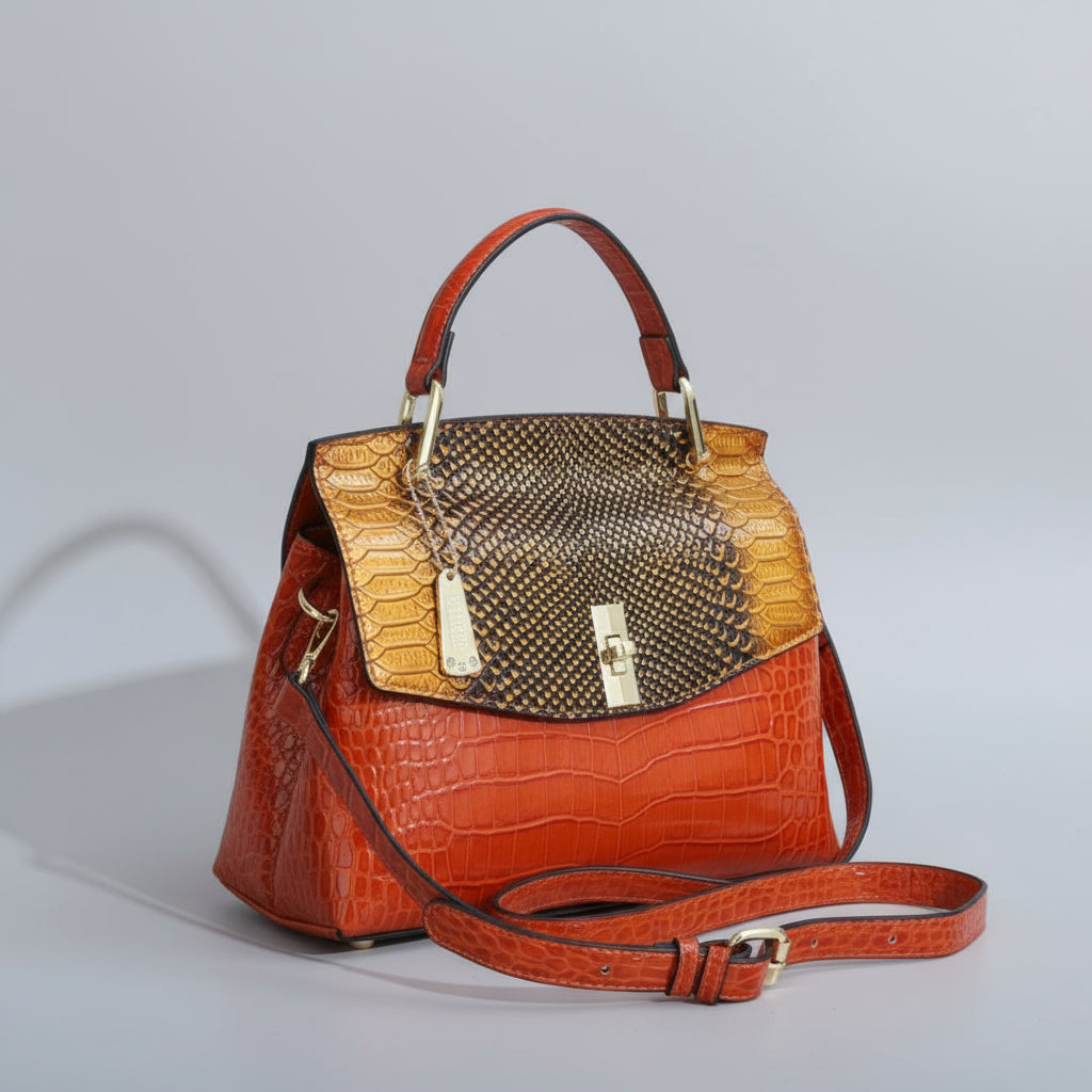 Brown and gold handbag with a strap on a white surface