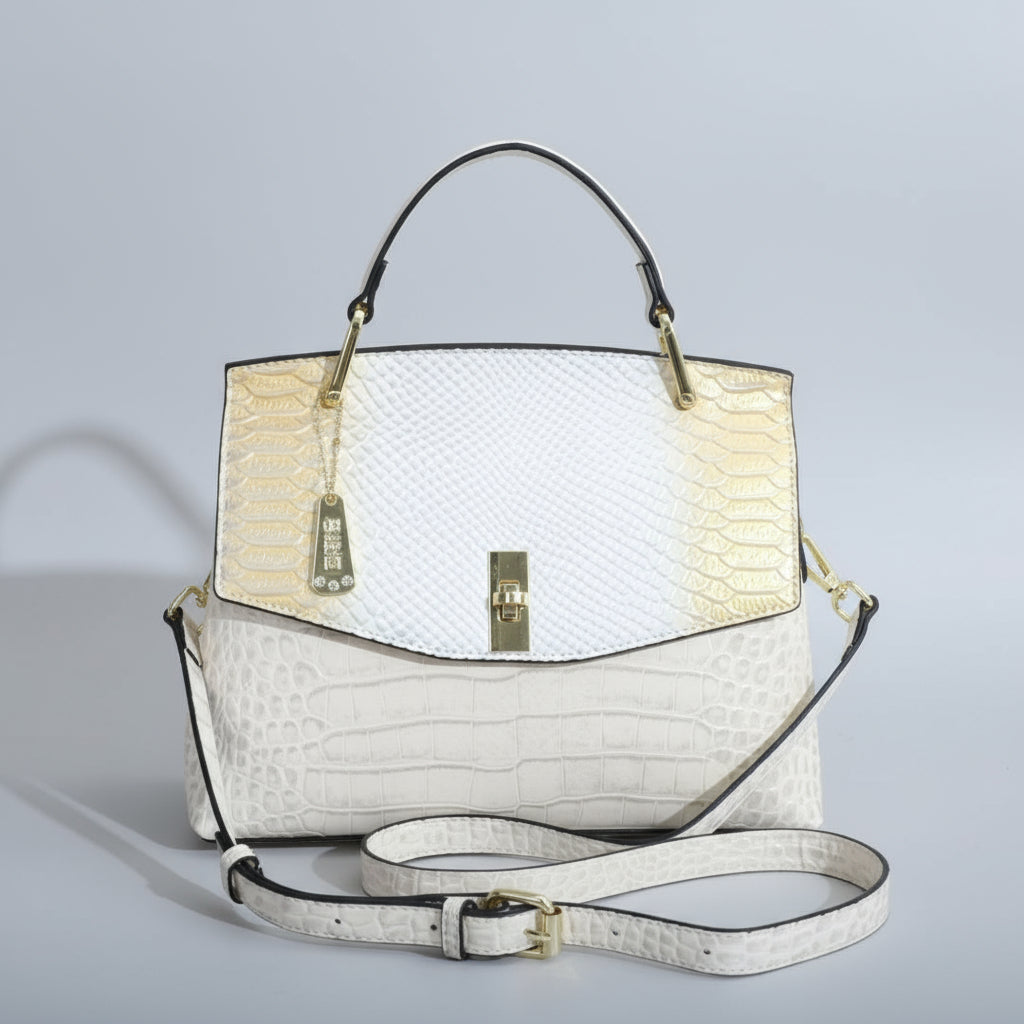 White handbag with gold accents on a white surface