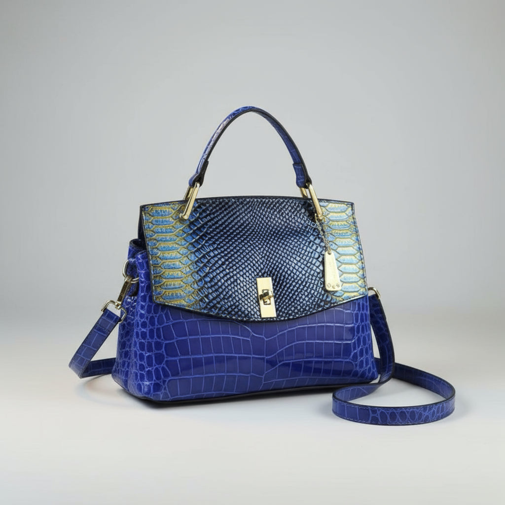 Blue textured handbag with gold accents on a white surface