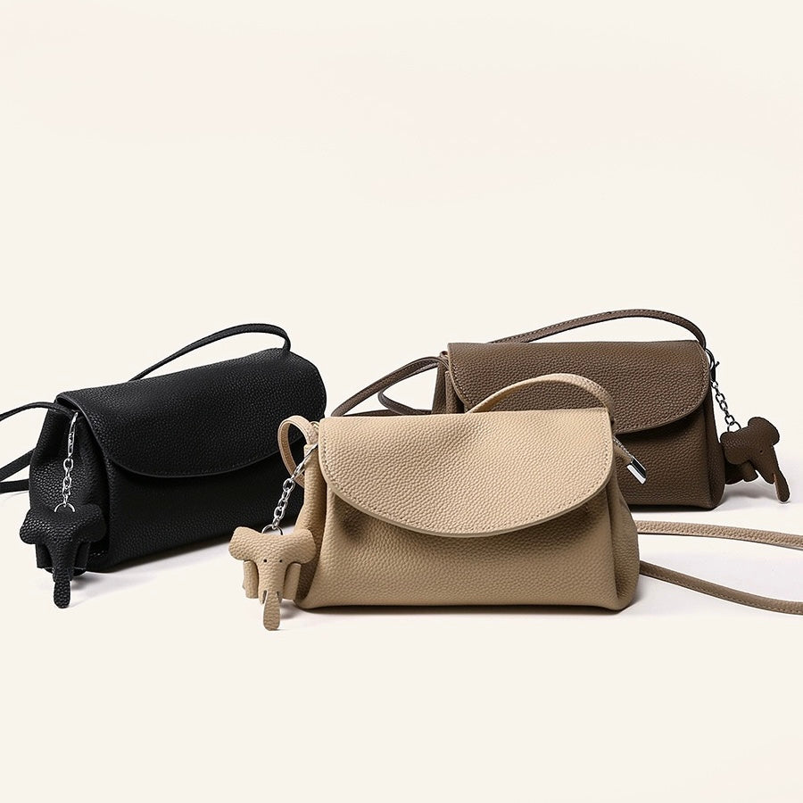 Elegant Cowhide Crossbody Bag with Mini Elephant Pendant