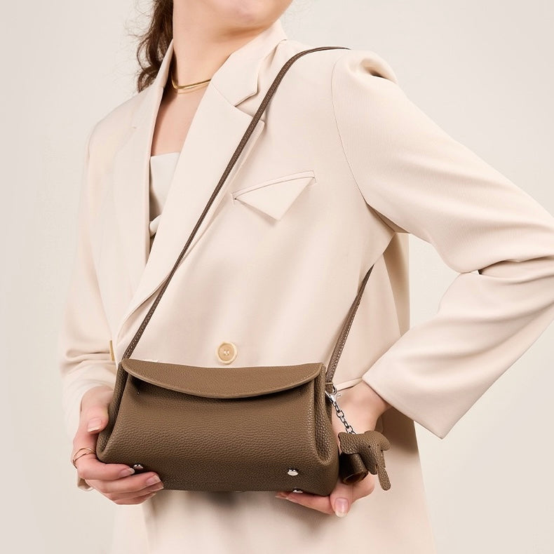 Elegant Cowhide Crossbody Bag with Mini Elephant Pendant