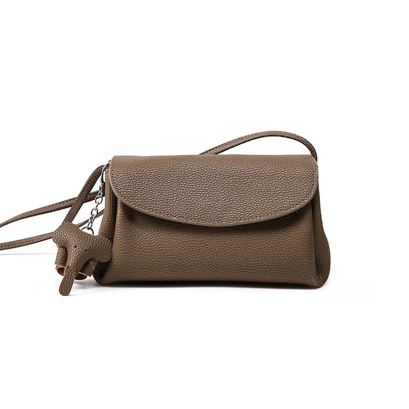 Elegant Cowhide Crossbody Bag with Mini Elephant Pendant