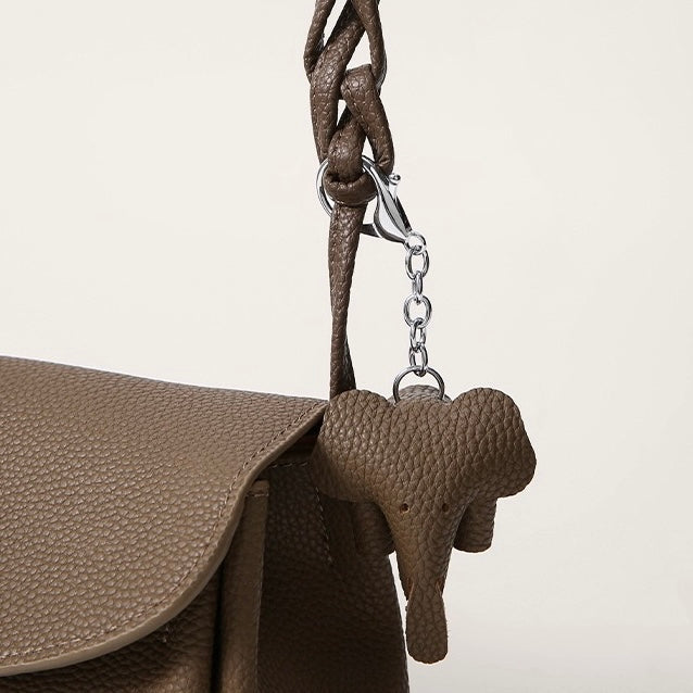 Elegant Cowhide Crossbody Bag with Mini Elephant Pendant