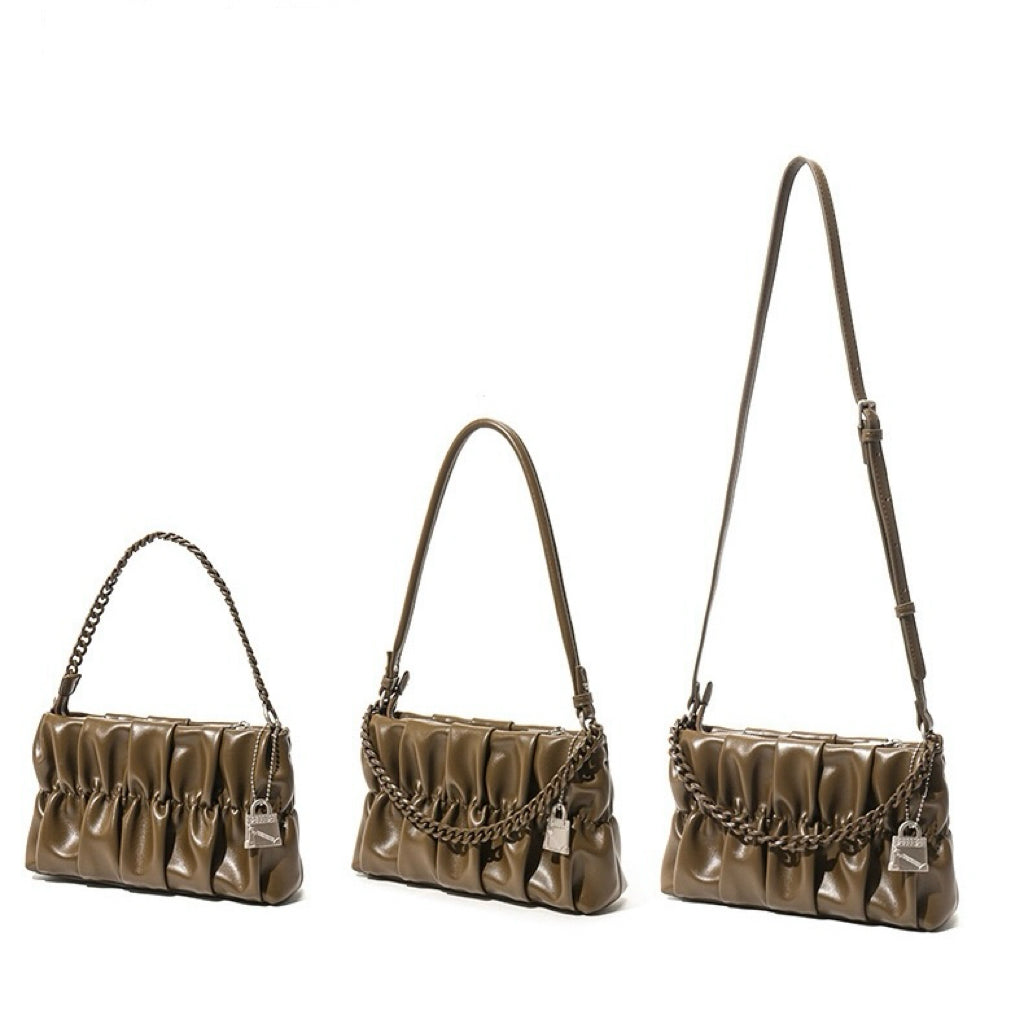 Three brown handbags with chain details on a white background