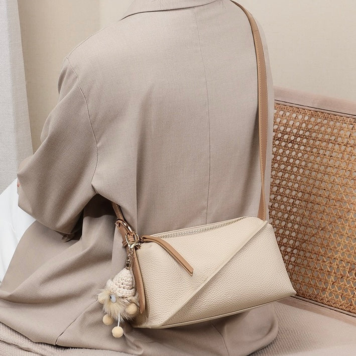 Chic Geometric Leather Crossbody Bag with Plush Charm