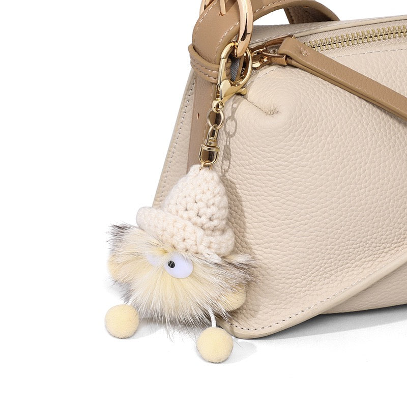 Chic Geometric Leather Crossbody Bag with Plush Charm