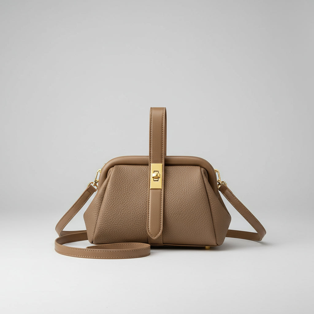 Brown leather handbag on a table with a book underneath, city lights in the background