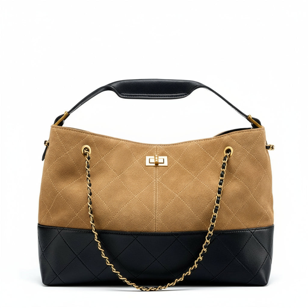 Tan and black handbag with gold chain on a white background