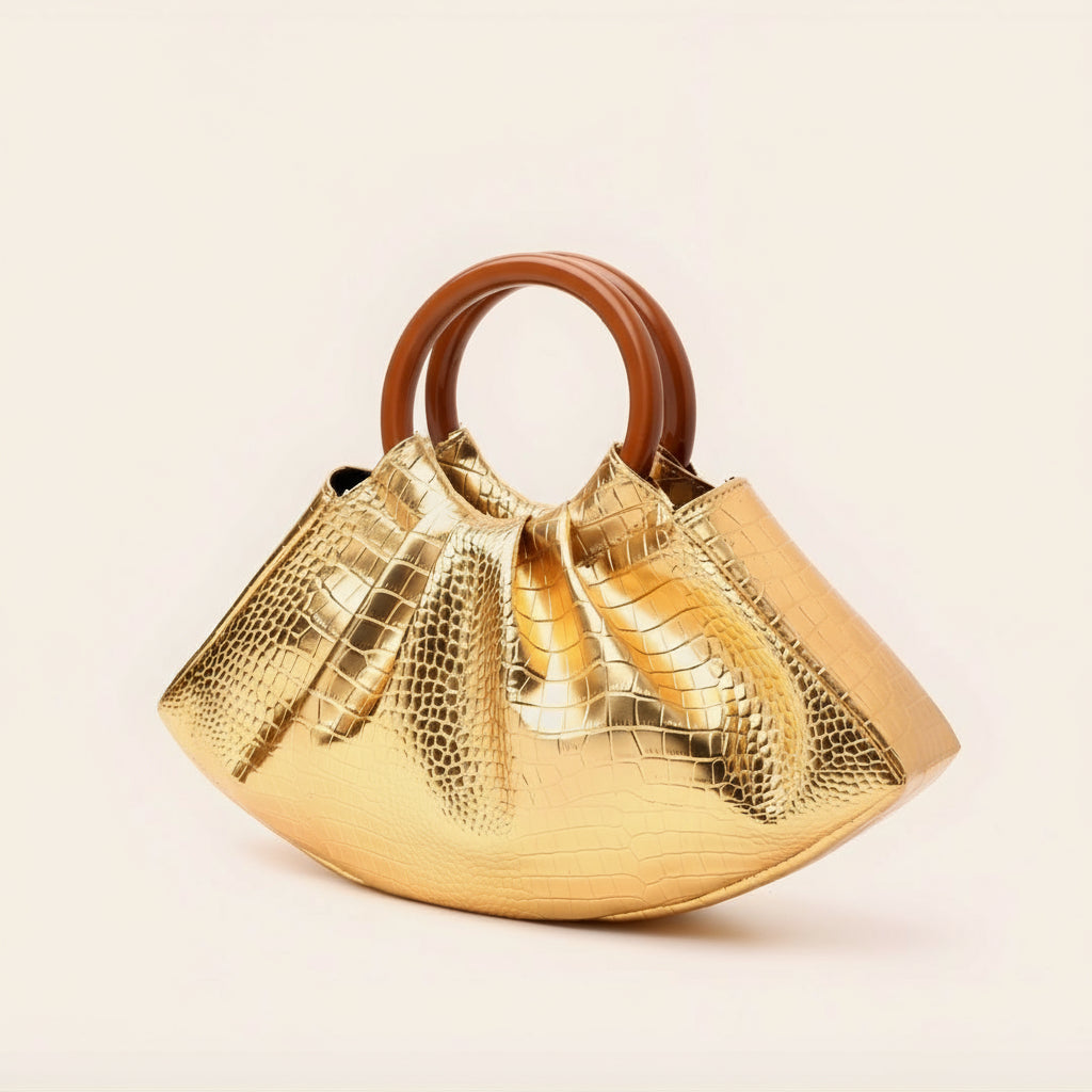 Gold handbag with brown handle on a beige background