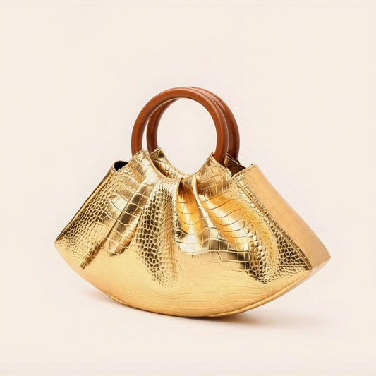 Gold handbag with brown handle on a beige background