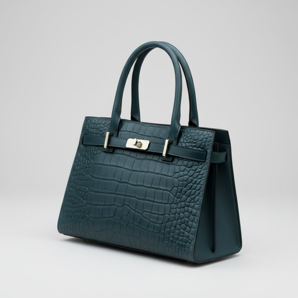 Blue textured handbag held by a person wearing a plaid coat.