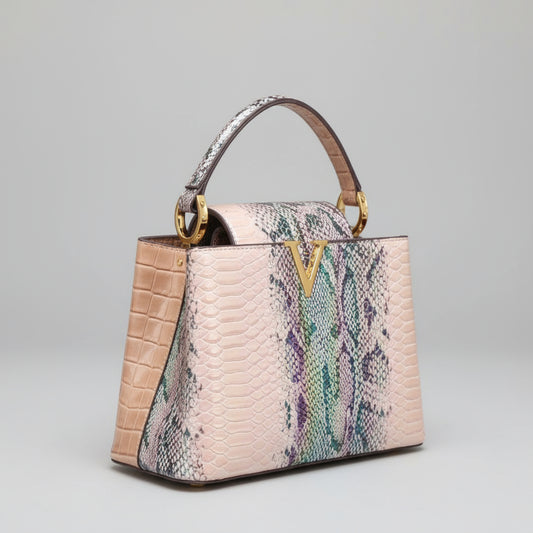 Designer handbag with colorful pattern on a wooden surface