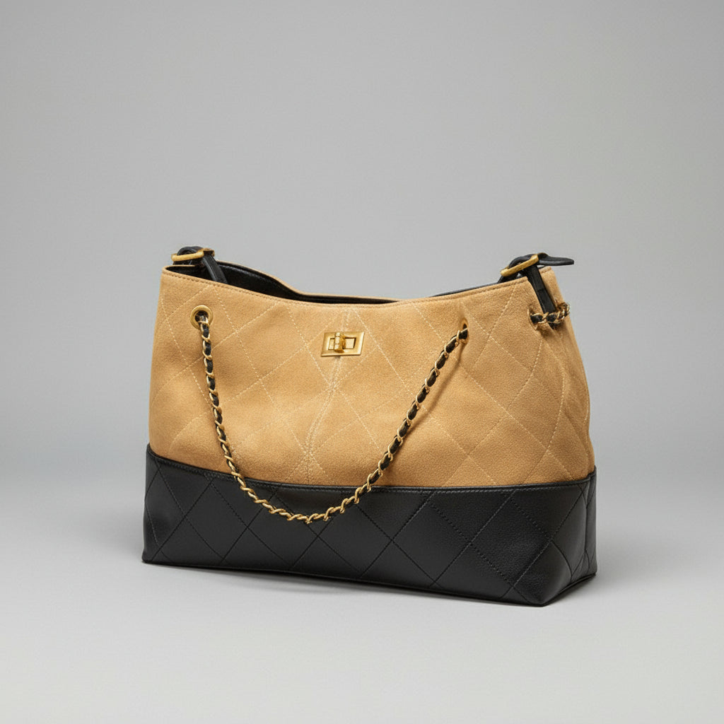 Quilted handbag with beige and black design on a brown surface with a pinkish-purple background