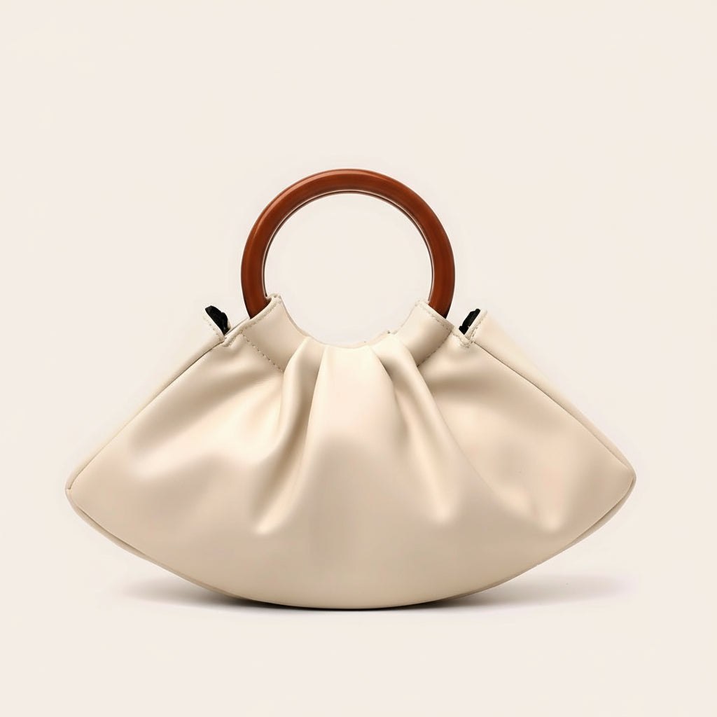 Beige handbag with wooden handle on a light beige background