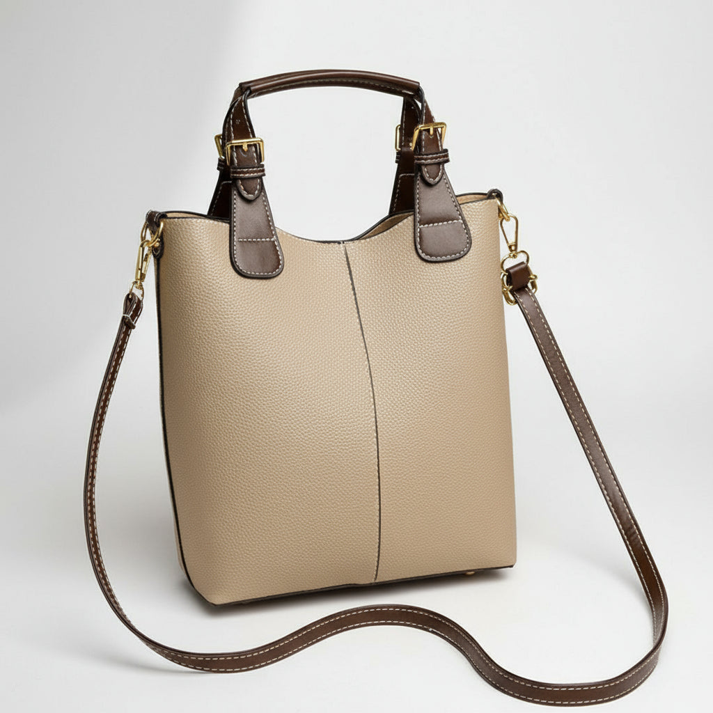Beige handbag with brown strap on a beige background