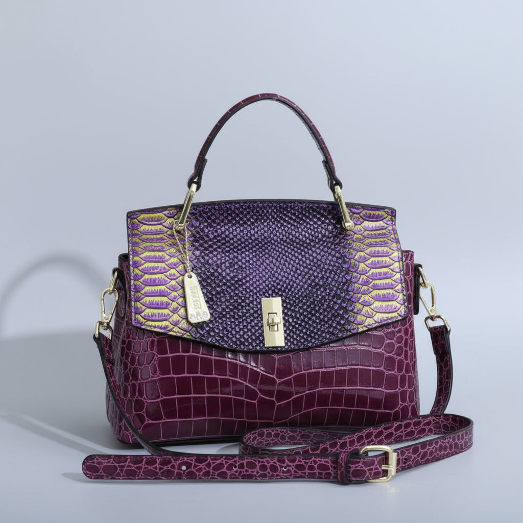 Purple handbag with gold accents on a white surface