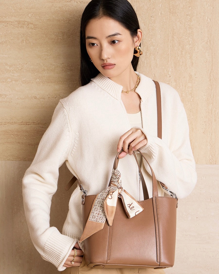 Elegant Leather Handbag with Signature Ribbon Detail