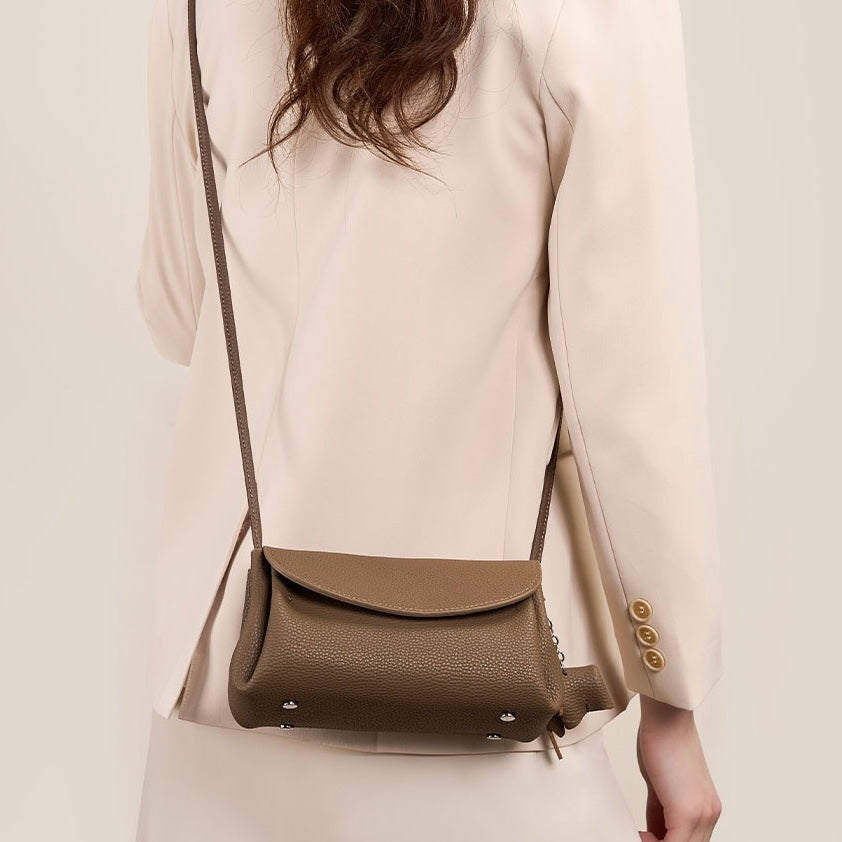 Elegant Cowhide Crossbody Bag with Mini Elephant Pendant