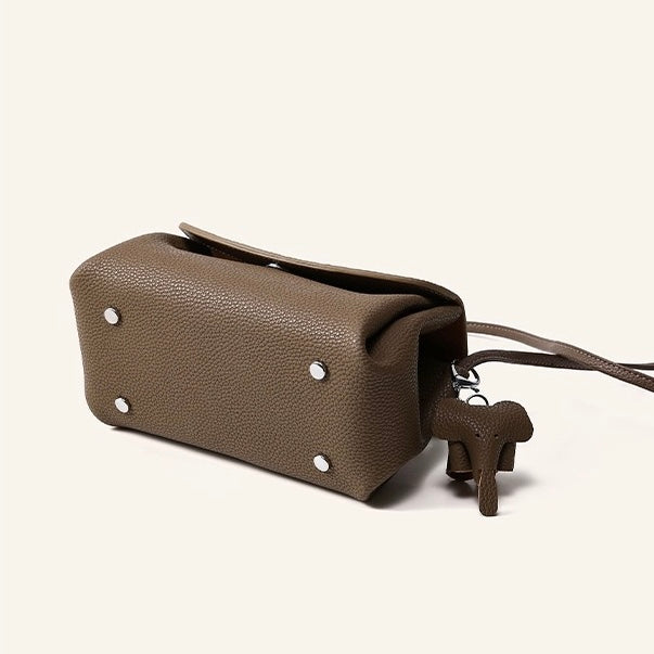 Elegant Cowhide Crossbody Bag with Mini Elephant Pendant