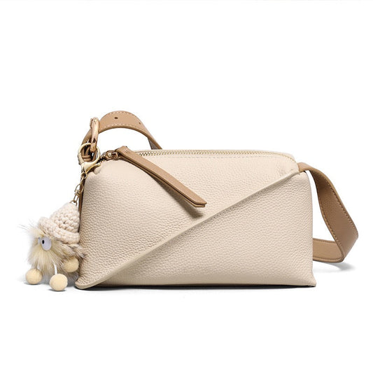 Chic Geometric Leather Crossbody Bag with Plush Charm