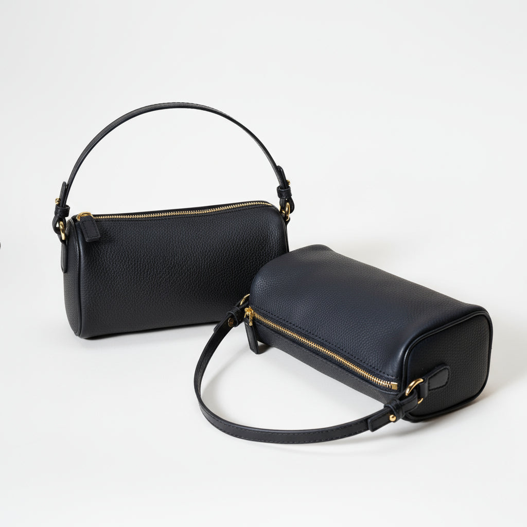 Brown handbag and black crossbody bag on a beige background