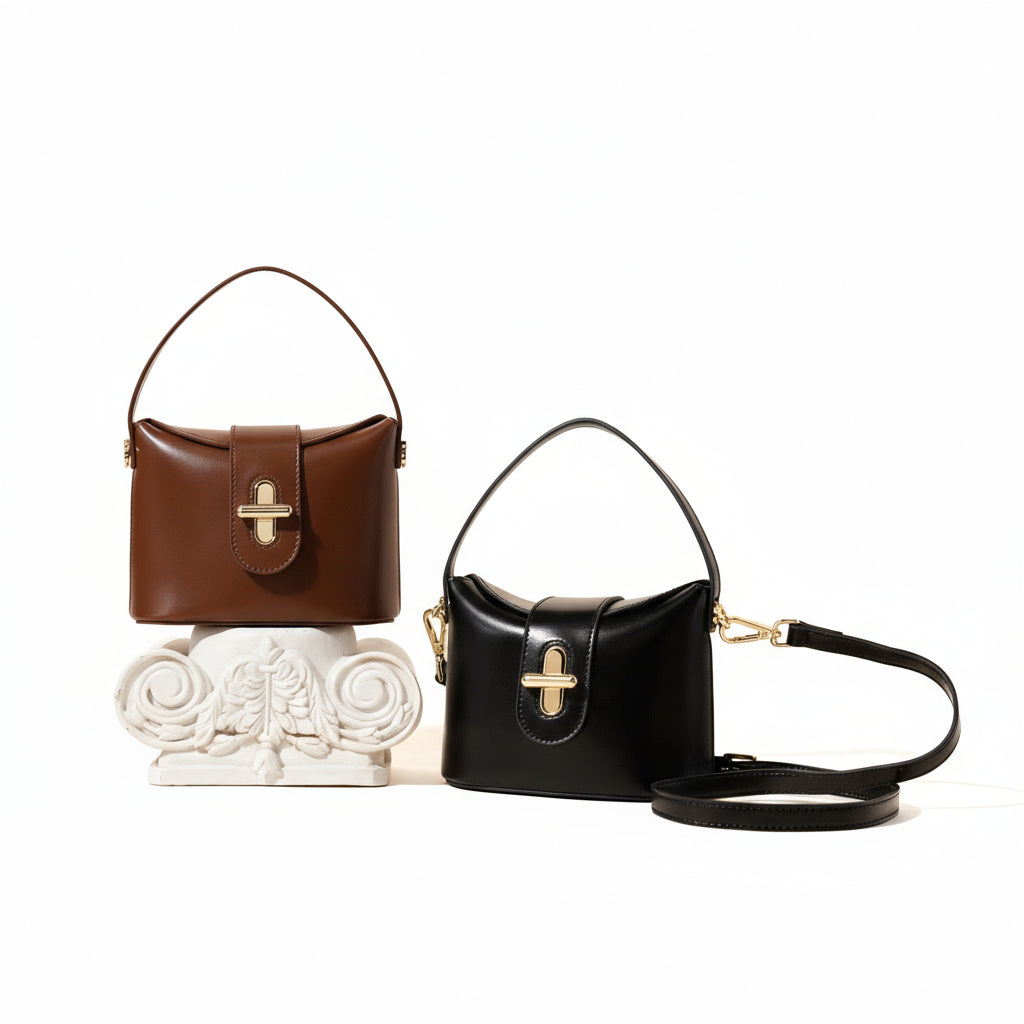 Brown and black handbags with gold clasps on a beige background