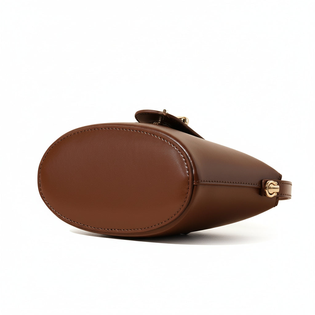 Brown leather handbag on a beige background