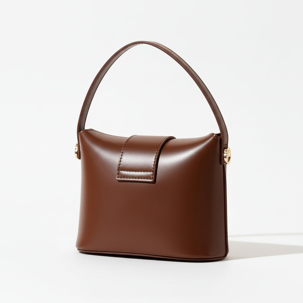 Brown leather handbag on a beige background