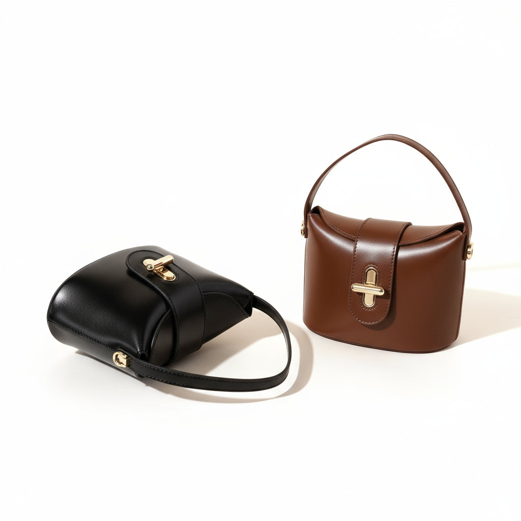 Black and brown handbags with gold hardware on a beige background