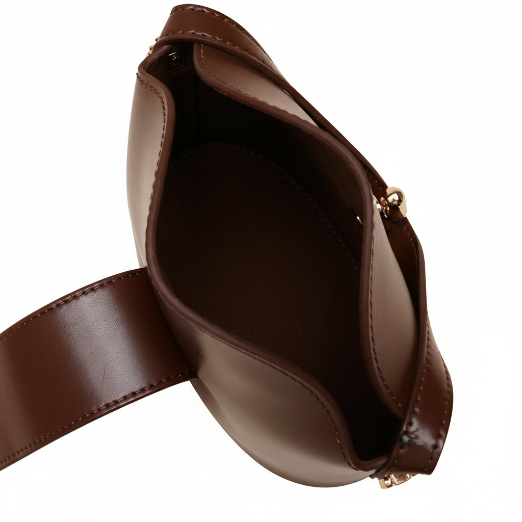 Brown leather bag on a beige background