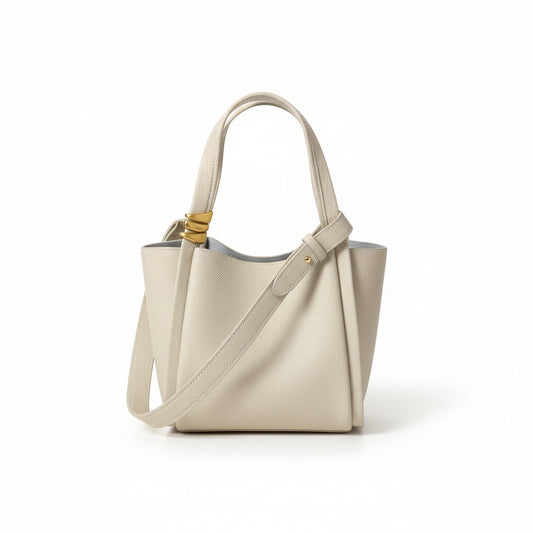 Beige handbag with a strap on a light background