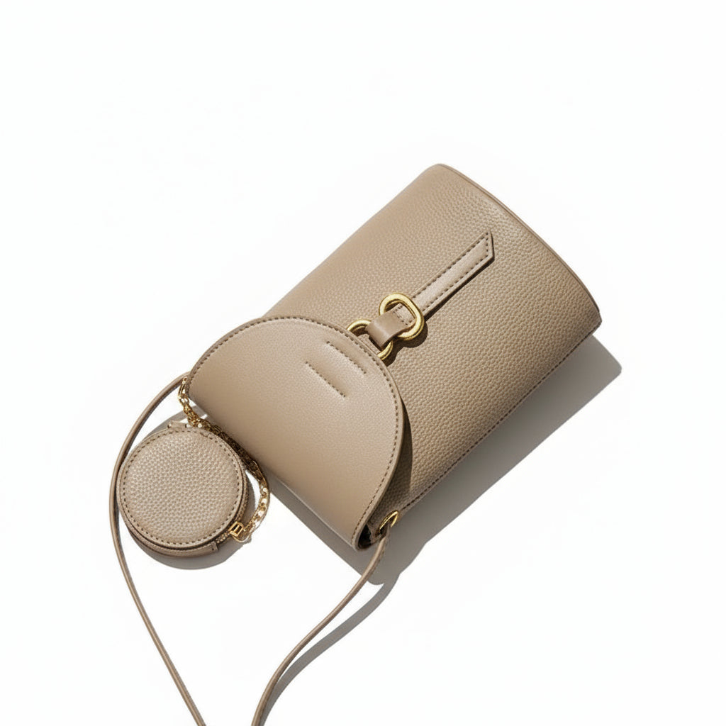 Beige handbag with a heart-shaped detail on a textured surface