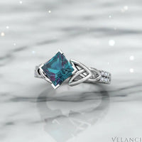 Silver ring with a large blue gemstone on a white background | Velanci Womens Ring