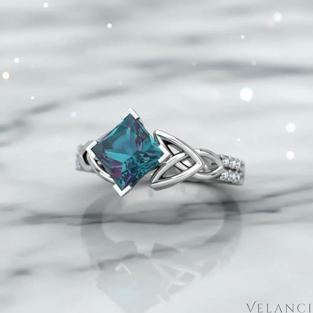 Silver ring with a large blue gemstone on a white background | Velanci Womens Ring