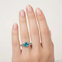 Silver ring with a large blue gemstone on a white background | Velanci Womens Ring