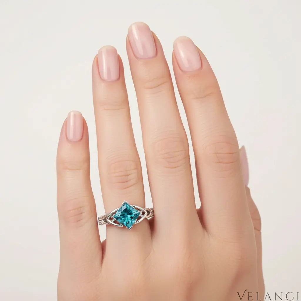 Silver ring with a large blue gemstone on a white background | Velanci Womens Ring