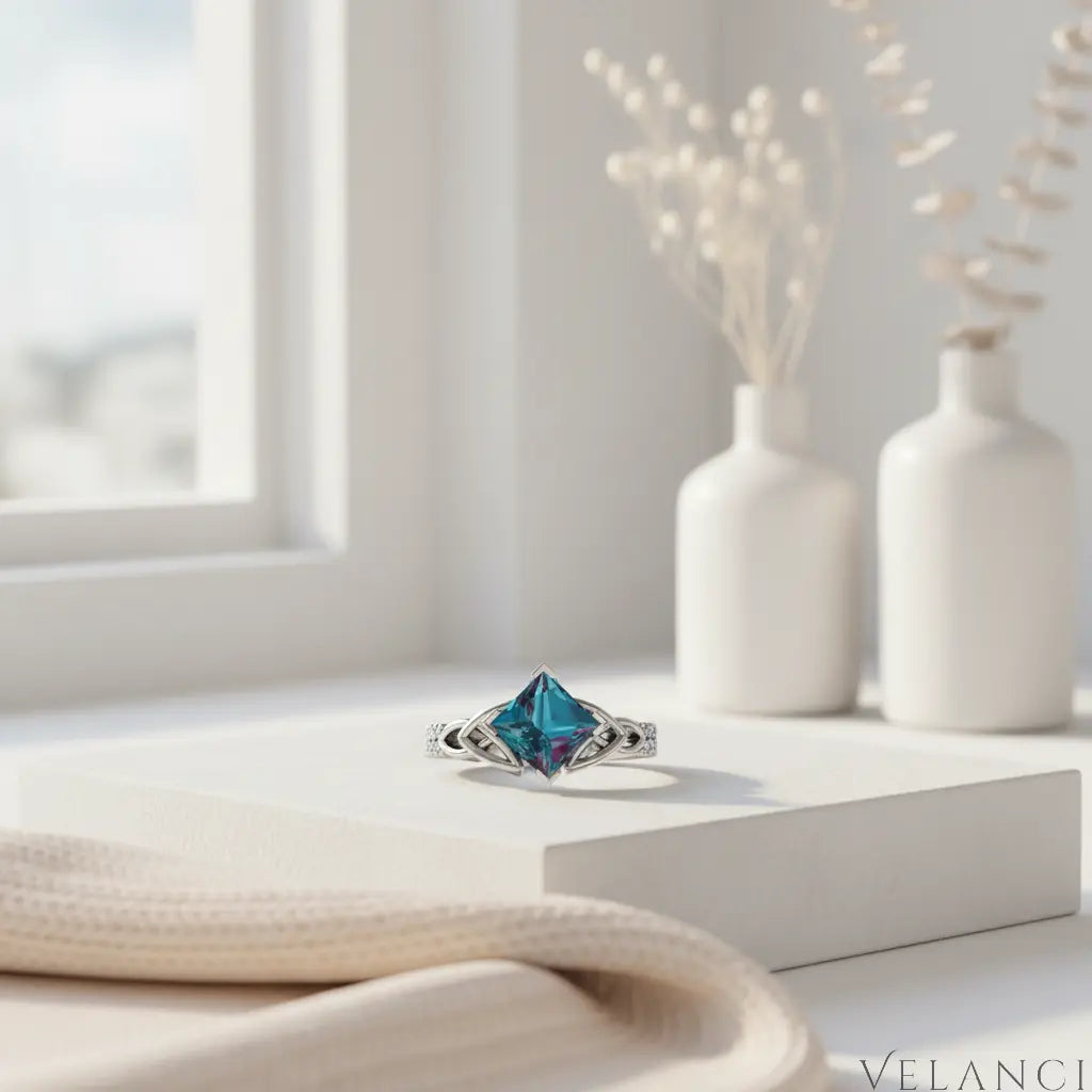 Silver ring with a large blue gemstone on a white background | Velanci Womens Ring