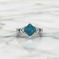 Silver ring with a large blue gemstone on a white background