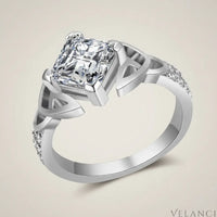 Silver ring with a large diamond and smaller diamonds on the band against a white background