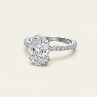 Diamond ring with a large central gemstone and smaller stones on a white background