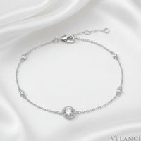 Silver bracelet with diamond-like stones on a white background