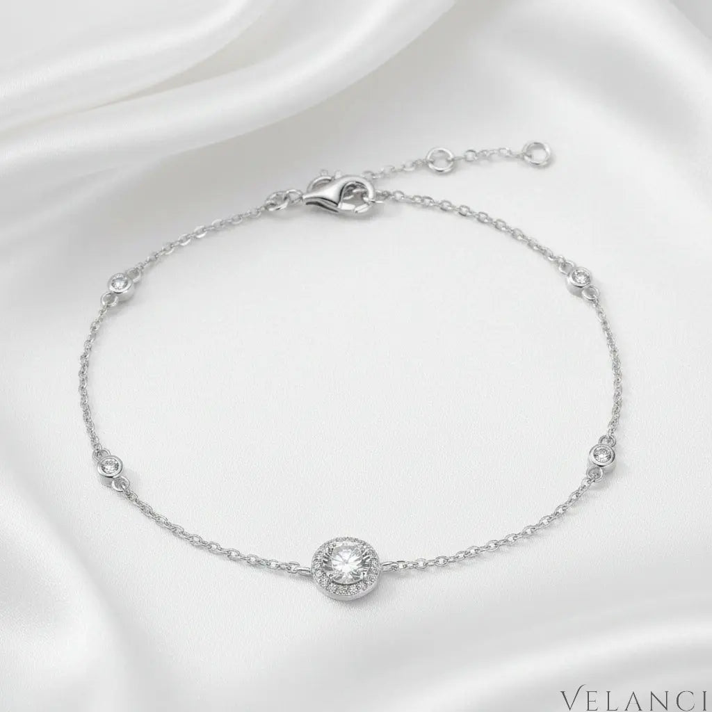 Silver bracelet with diamond-like stones on a white background