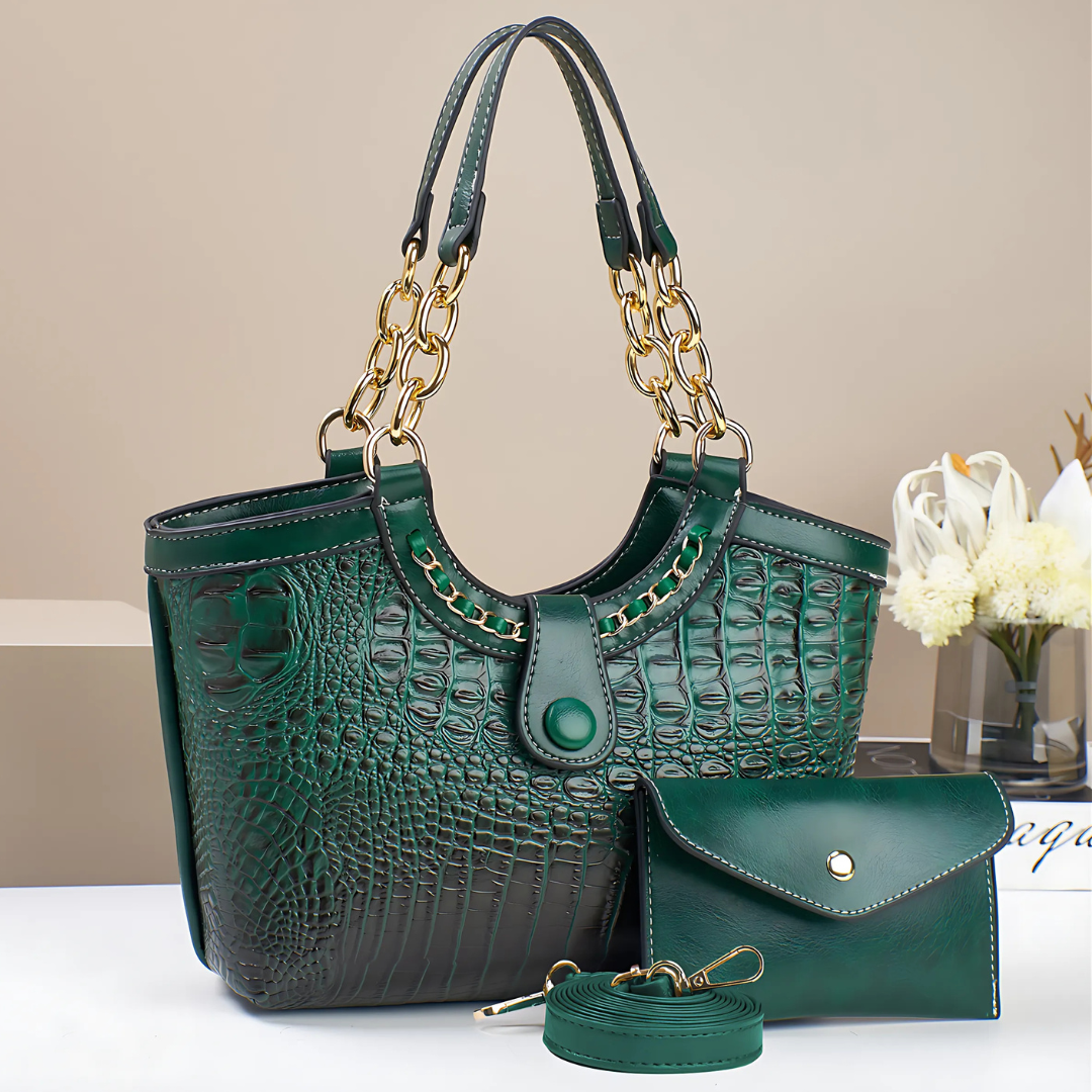 Green textured handbag with matching pouch on a light surface.