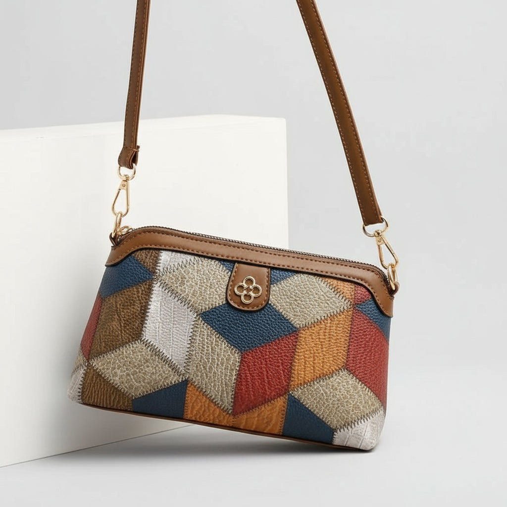 Multicolored geometric patterned handbag with brown strap on a beige background