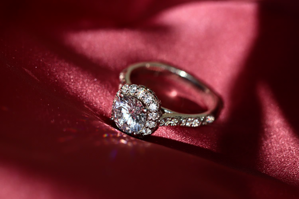 Diamond ring on a red fabric surface